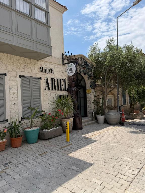 a building with a sign on the side of it at The Alaçatı Ariel Hotel in Çeşme