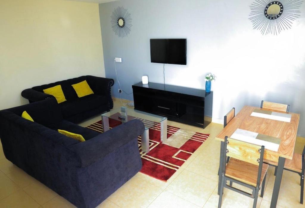 a living room with a couch and a table at 3 Bedrooms in Eldoret in Eldoret