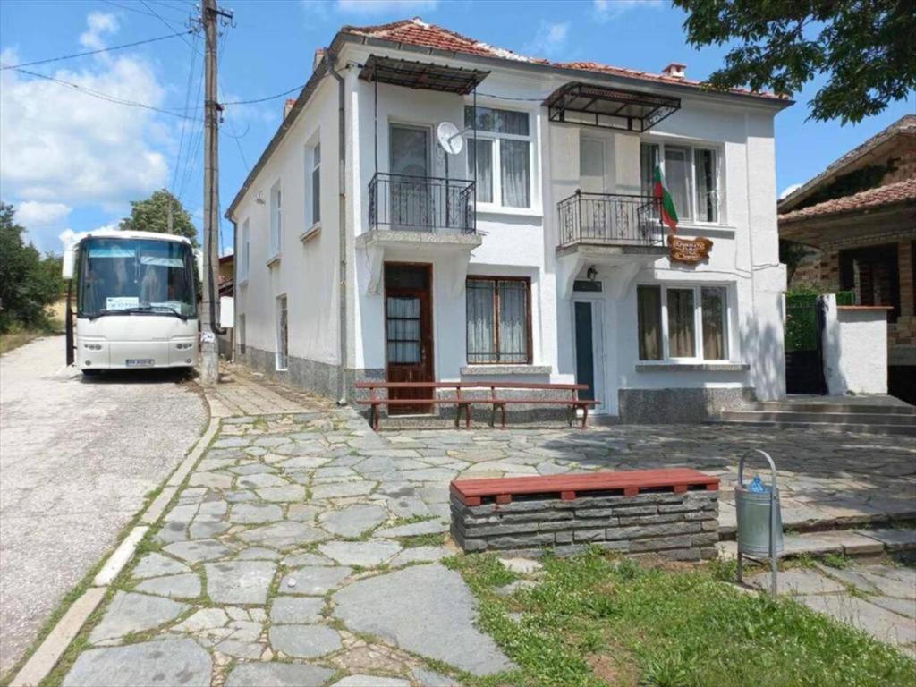 a bus is parked in front of a house at Душковата къща in Chekhlare