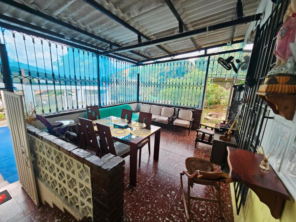 a dining room with a table and chairs and windows at VILLA ELSA in El Colegio