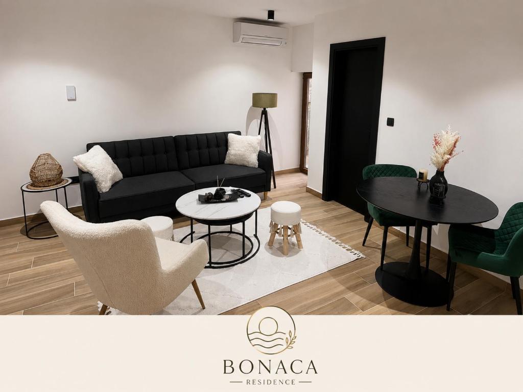 a living room with a couch and a table and chairs at Bonaca Residence in Makarska