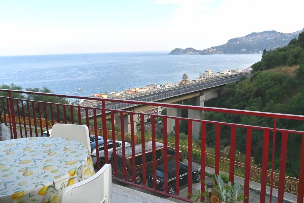 a balcony with a table and a view of the ocean at Maremonti in Letojanni