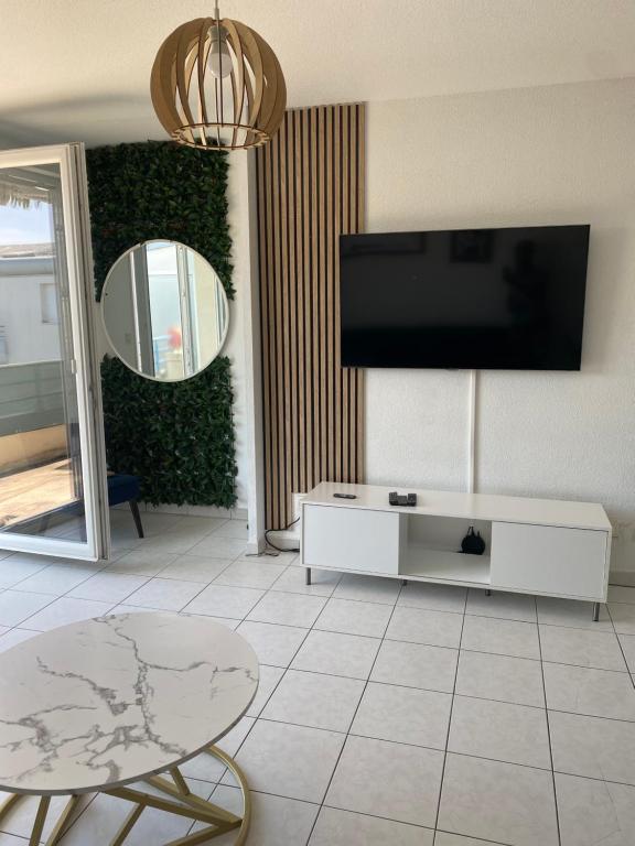 a living room with a flat screen tv on a wall at l'arc logement in Strasbourg