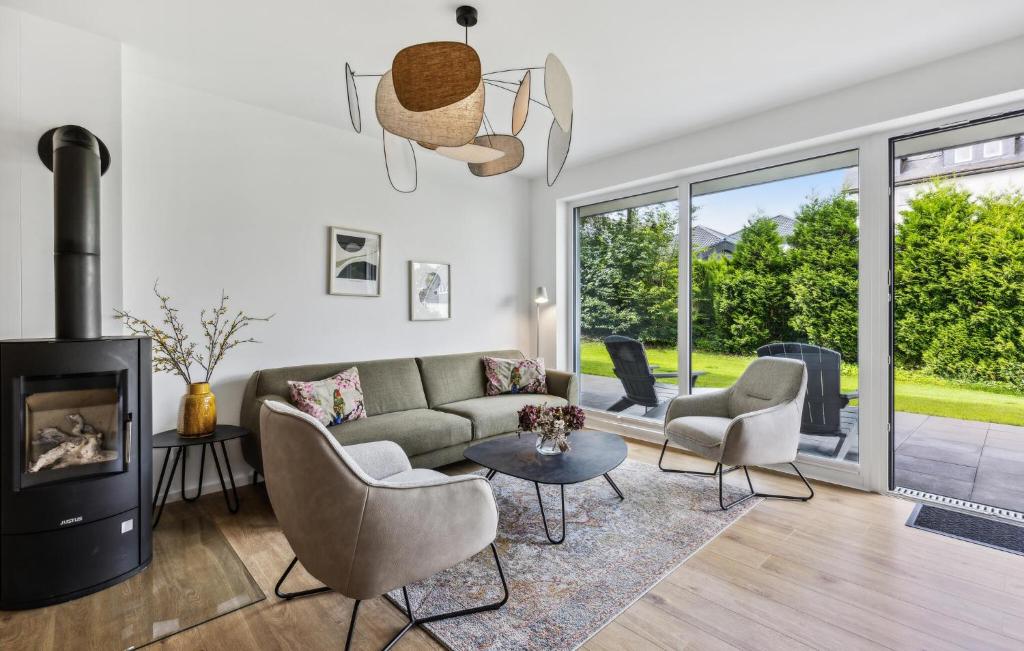 a living room with a couch and chairs and a fireplace at Ferienfreude in Winterberg