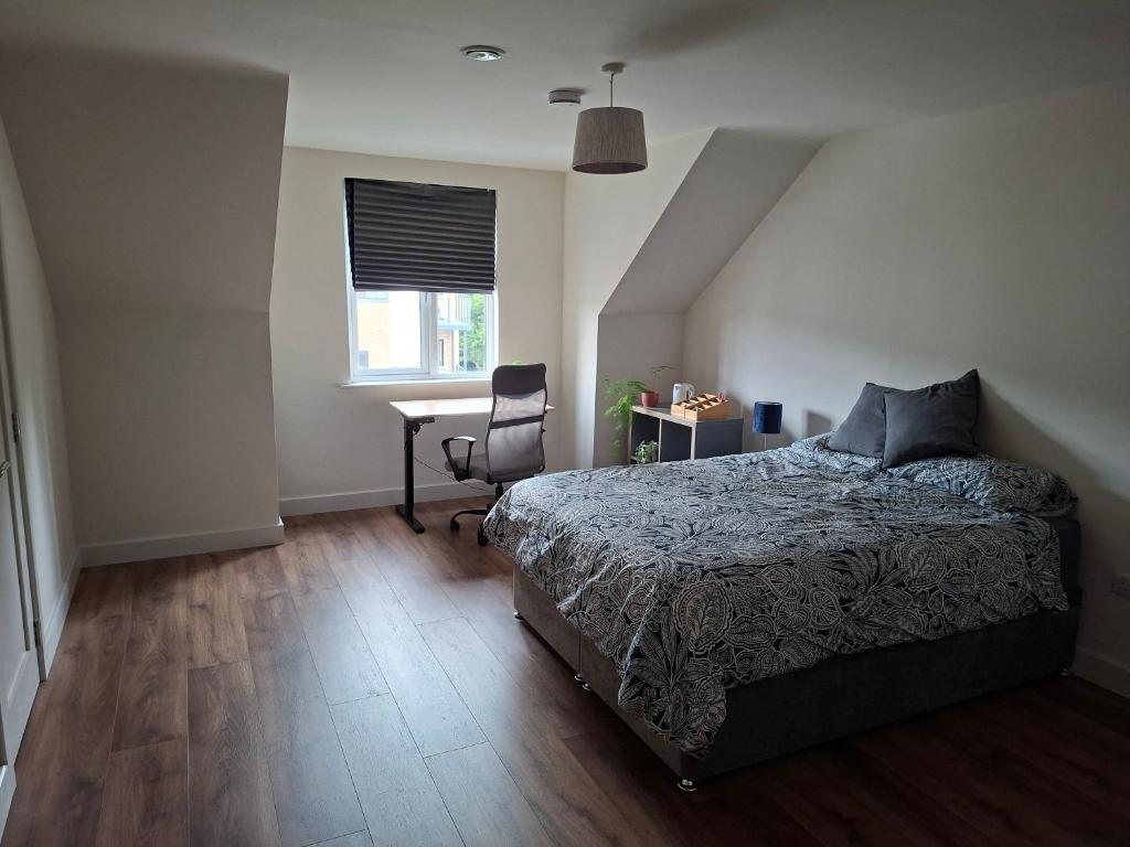 a bedroom with a bed and a desk in it at Spacious ensuite bedroom in Kiltiernan