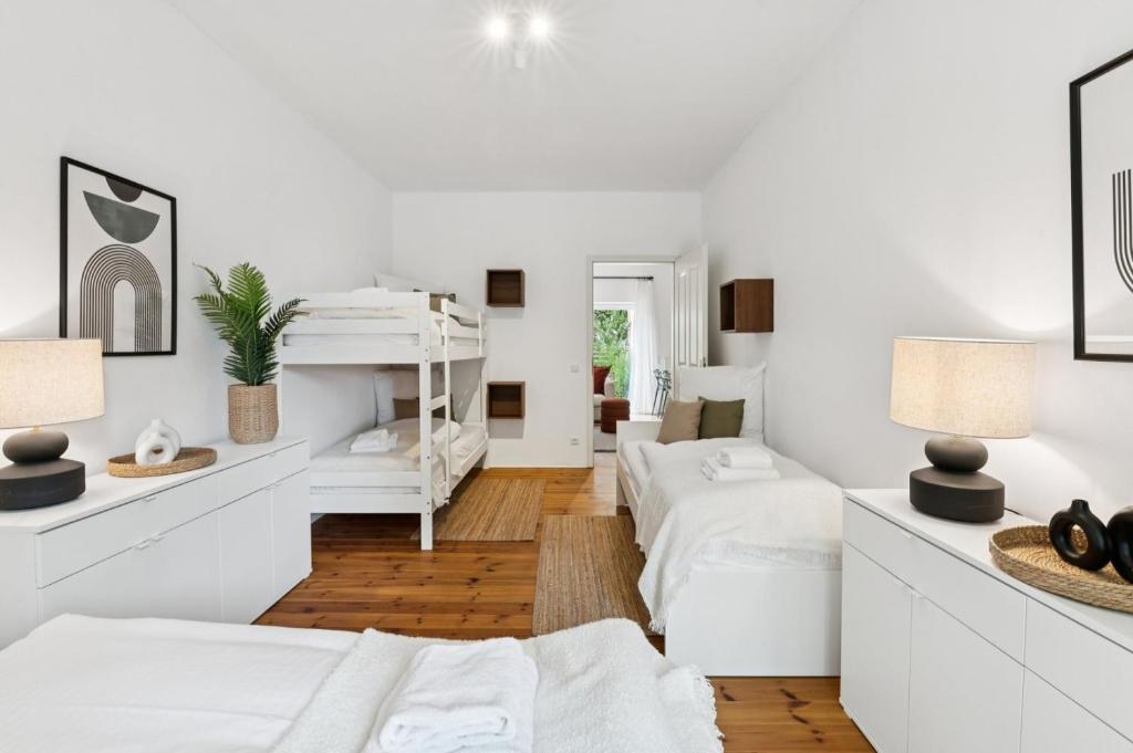 a white room with two beds and two lamps at Arbio Monteurzimmer Behnitzer Parking included in Nauen