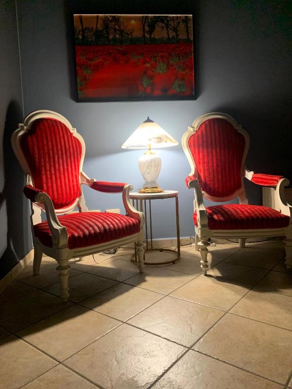 two chairs and a table with a lamp in a room at Appartamenti della Marchesa 2 camere in Montichiari