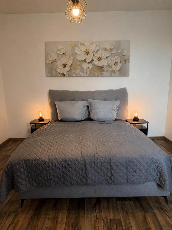 a bedroom with a bed with two night stands at Apartmán Pardubice 4 in Pardubice