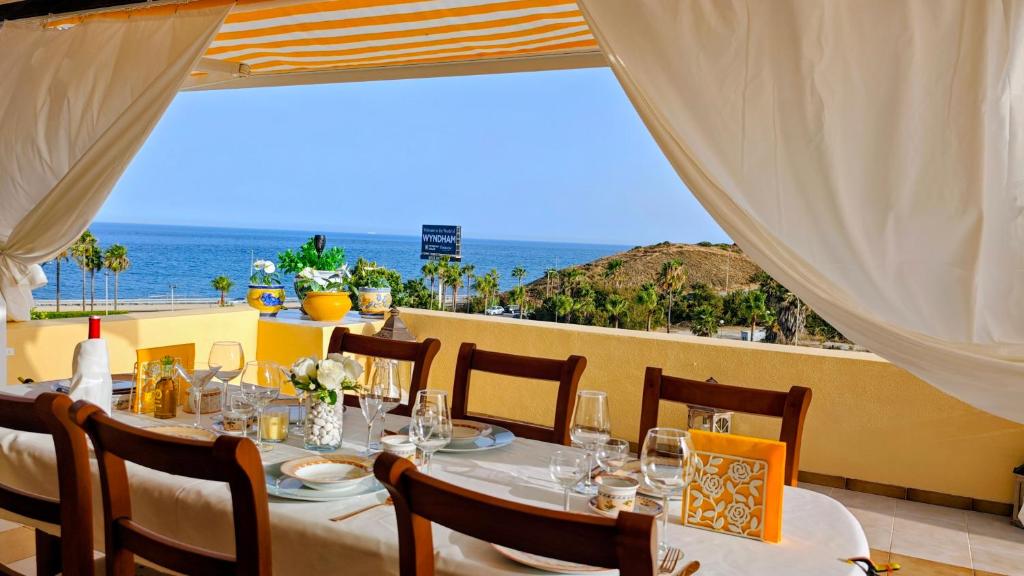 a dining table with a view of the ocean at Tango Andaluz - Sunset Ritual Incl in Fuengirola