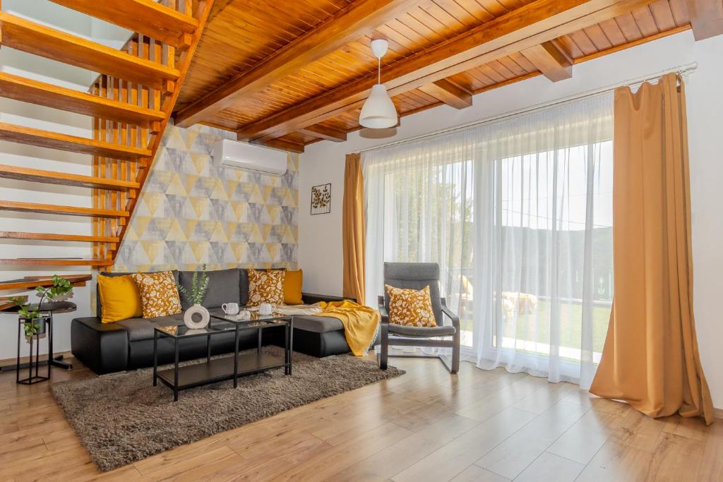 a living room with a couch and a table at Panorámaház Bükkszék in Bükkszék
