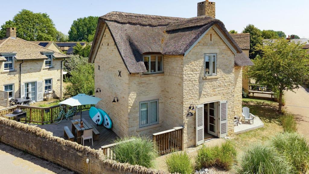an aerial view of a house with a patio at Moorhens in Somerford Keynes
