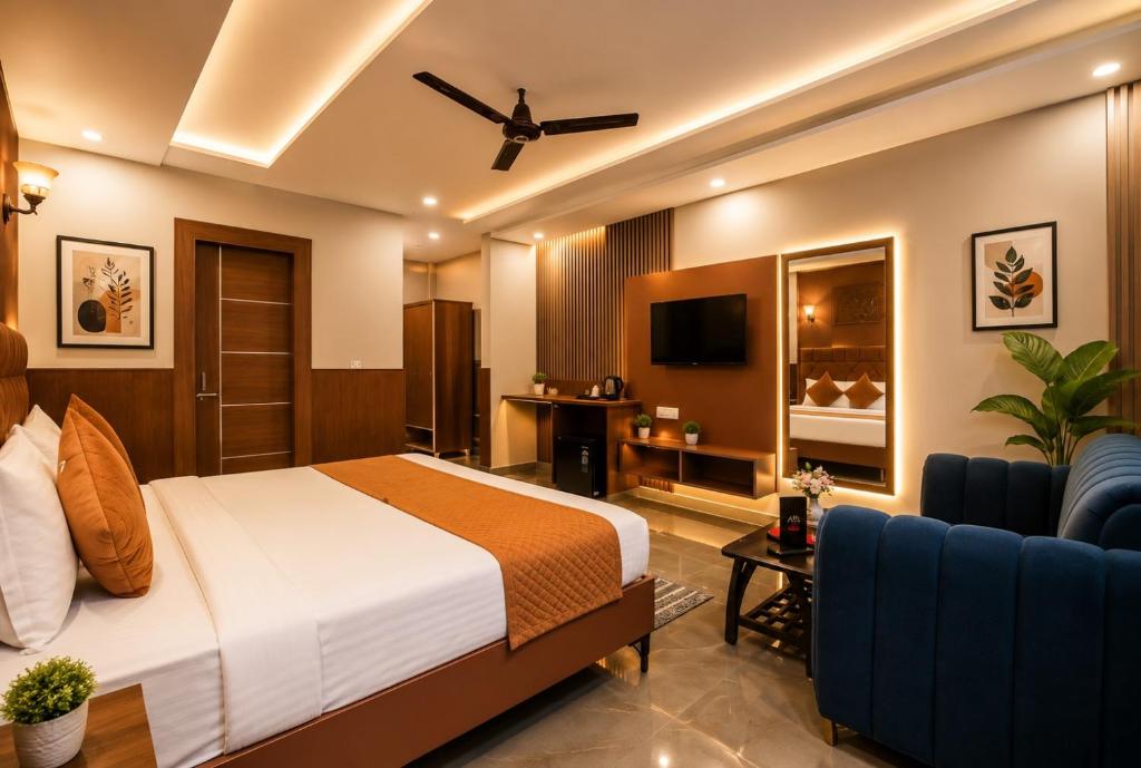 a hotel room with a bed and a couch at Hotel Jiio in Kurukshetra