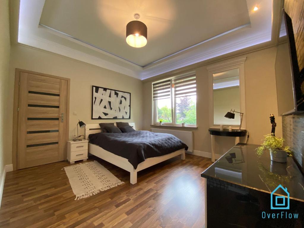 a bedroom with a bed and a window at NaWypasie Apartment with Sauna Beautiful Garden SUP Board and Just 30 Minutes from Gdańsk and Gdynia in Szemud