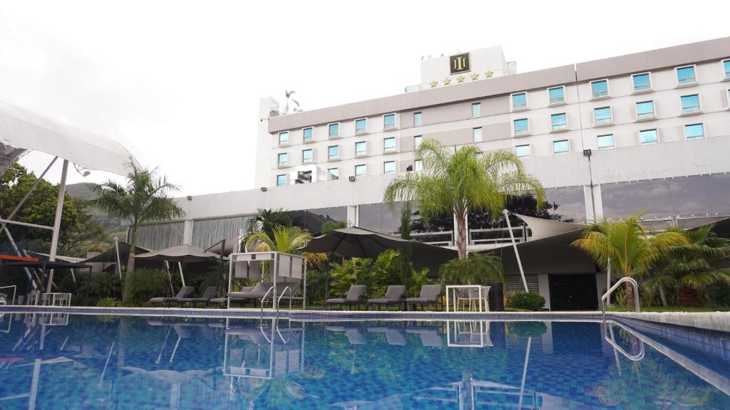 a hotel with a swimming pool in front of a building at Hotel & Casino Internacional Valencia in Valencia