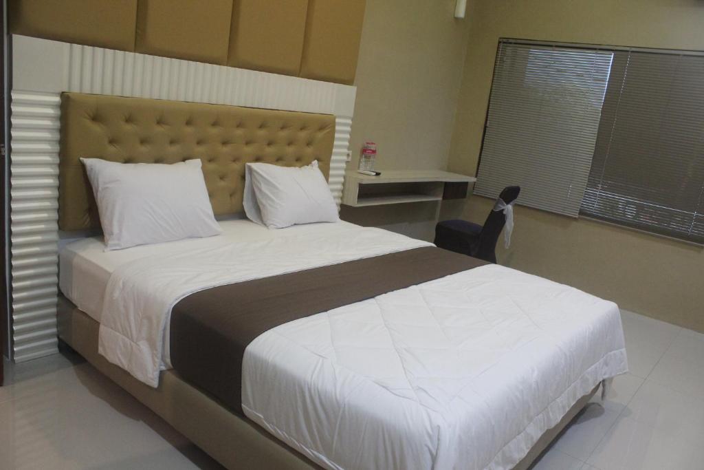Postel nebo postele na pokoji v ubytování Cyka Raya Hotel