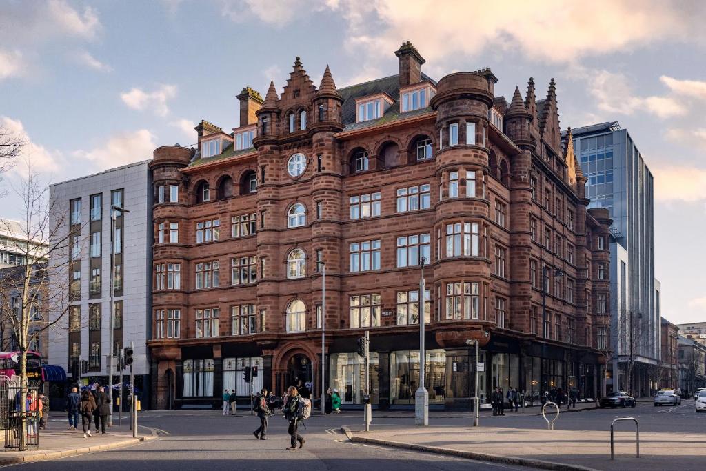 a large brick building with a clock on it at The Bedford Hotel Belfast in Belfast