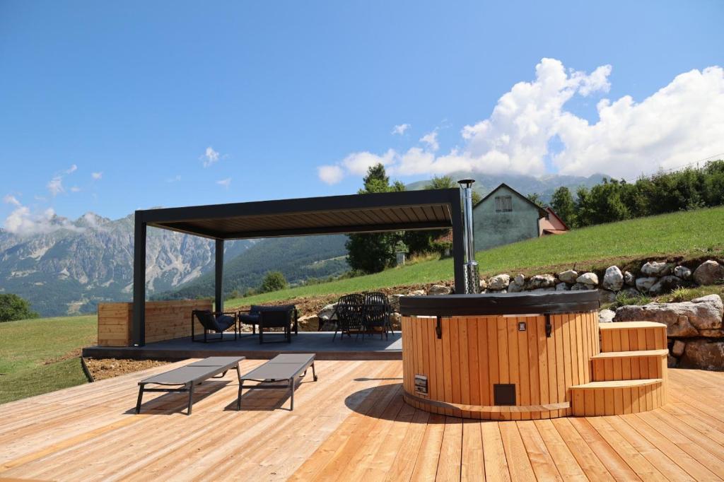 a wooden deck with benches and a gazebo at Cinque Sensi Wellness Apartments in Braz