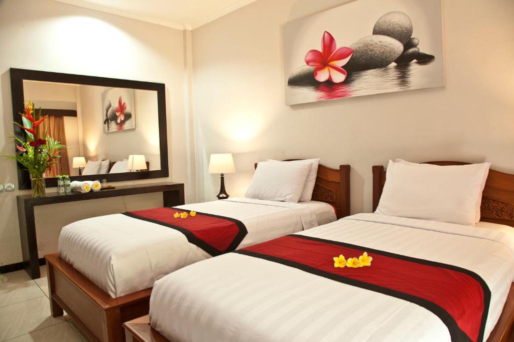 Postel nebo postele na pokoji v ubytování Jepun Bali Hotel
