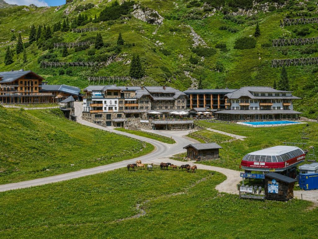 a group of buildings on a hill with a winding road at Hotel das Seekarhaus in Obertauern