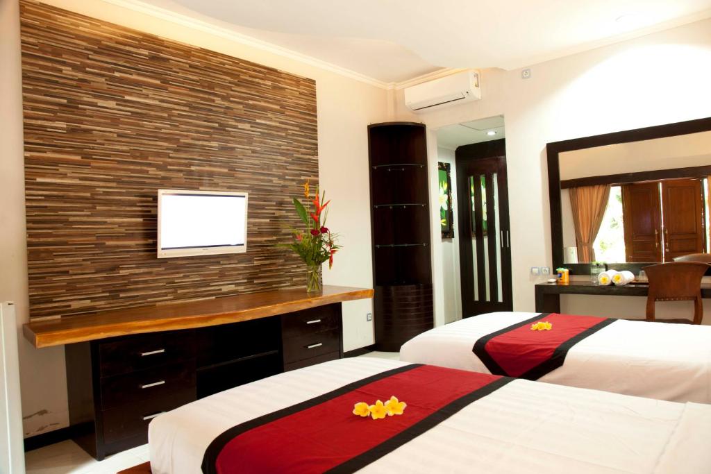 Postel nebo postele na pokoji v ubytování Jepun Bali Hotel