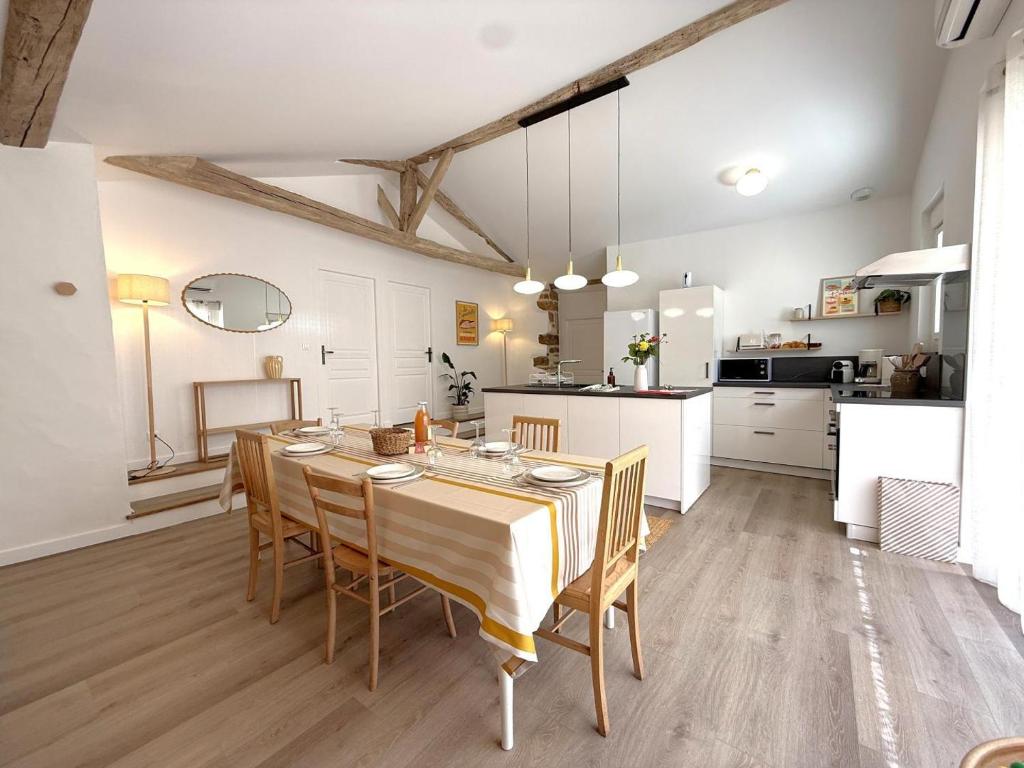 a kitchen and dining room with a table and chairs at Etxean irria in Hasparren