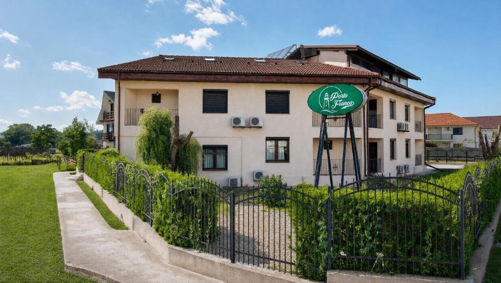 a house with a sign in front of a fence at Porto Franco Sulina in Sulina