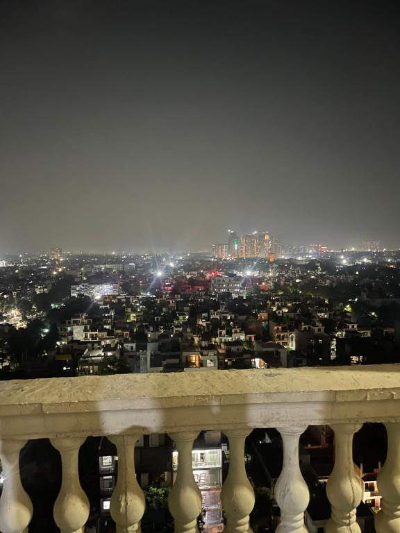 a view of a city at night from a balcony at Corestay in Greater Noida
