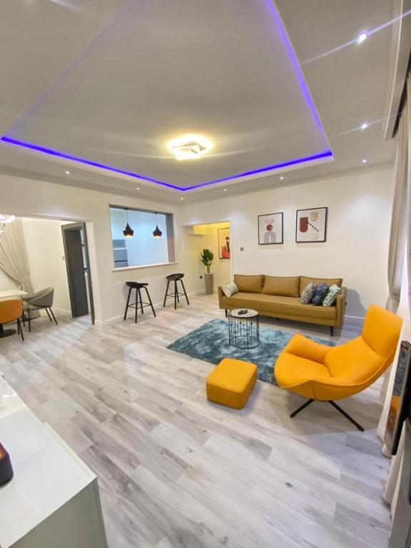 a living room with a couch and a table at Aprils homes & apartments in Ankuru