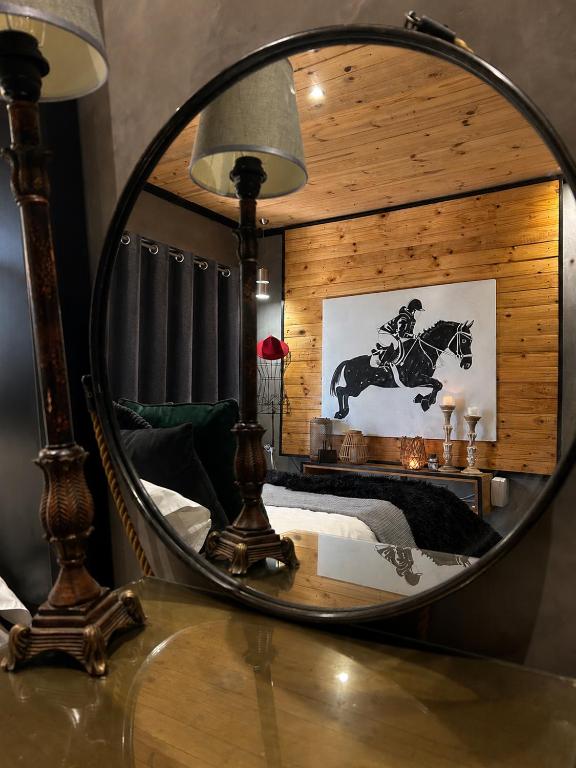 a mirror on top of a table in a bedroom at FollyFoot Manor in Midrand
