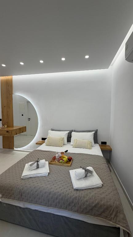 a bedroom with a large bed with towels on it at Naxian Roots in Galini