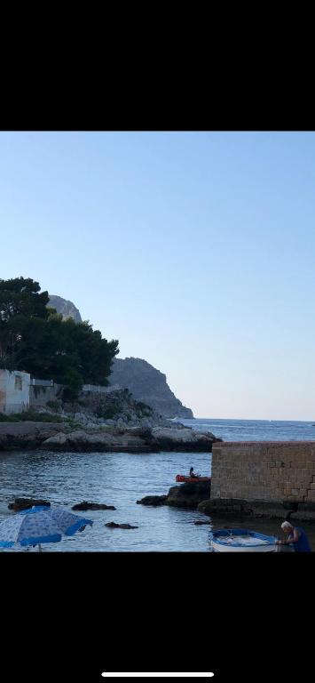 a view of a body of water with a mountain at La casa al mare in Palermo