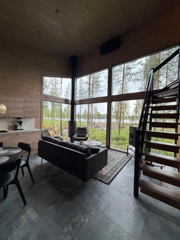 a living room with a couch and a table at Tyven Resort in Sirkkakoski