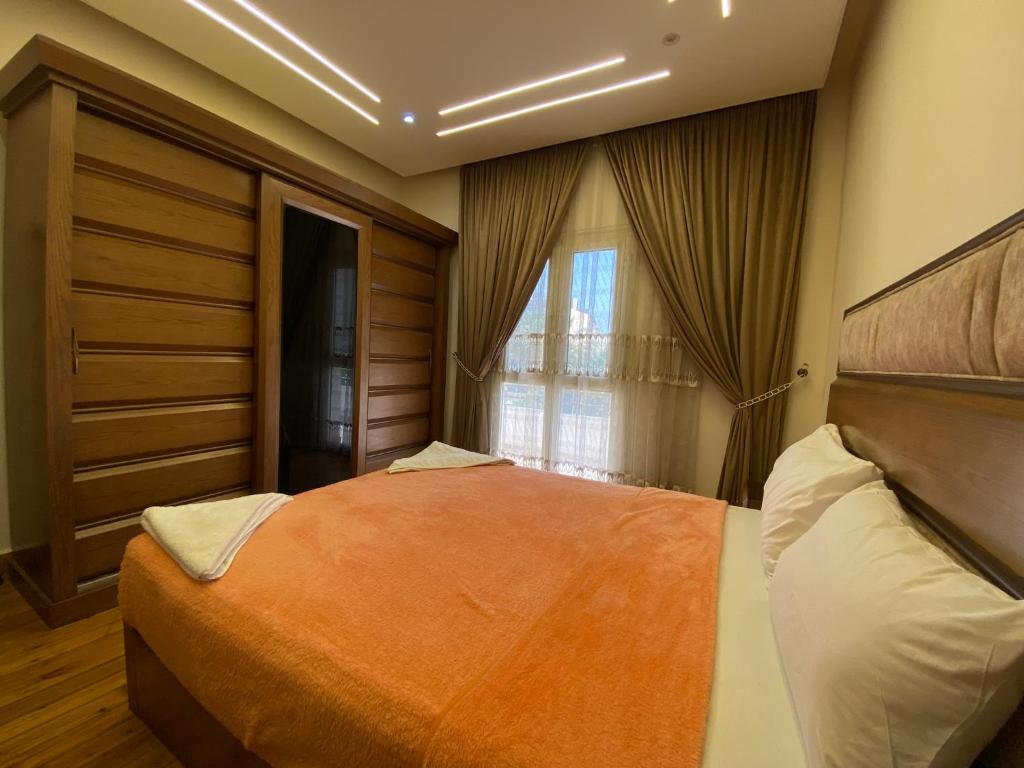 a bedroom with a large bed and a window at Luxury Apartments - Downtown Cairo in Cairo