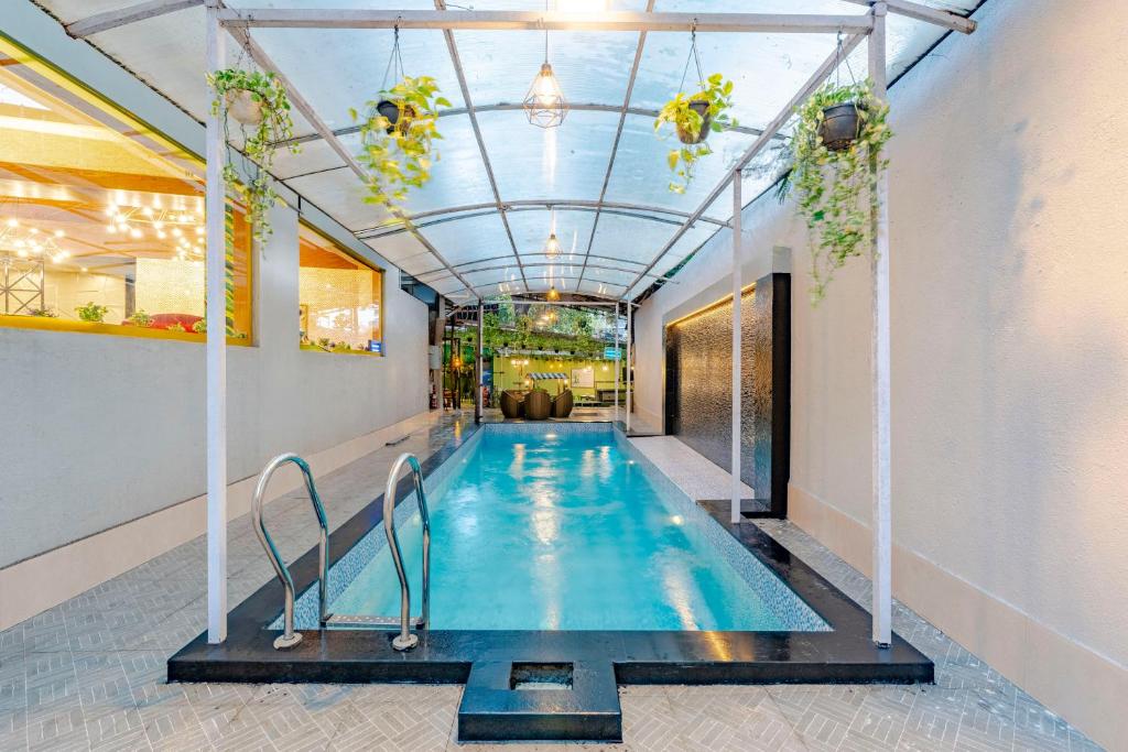 a swimming pool in a building with a ceiling at Treebo Premium Widlor Boutique with Swimming Pool in Mumbai