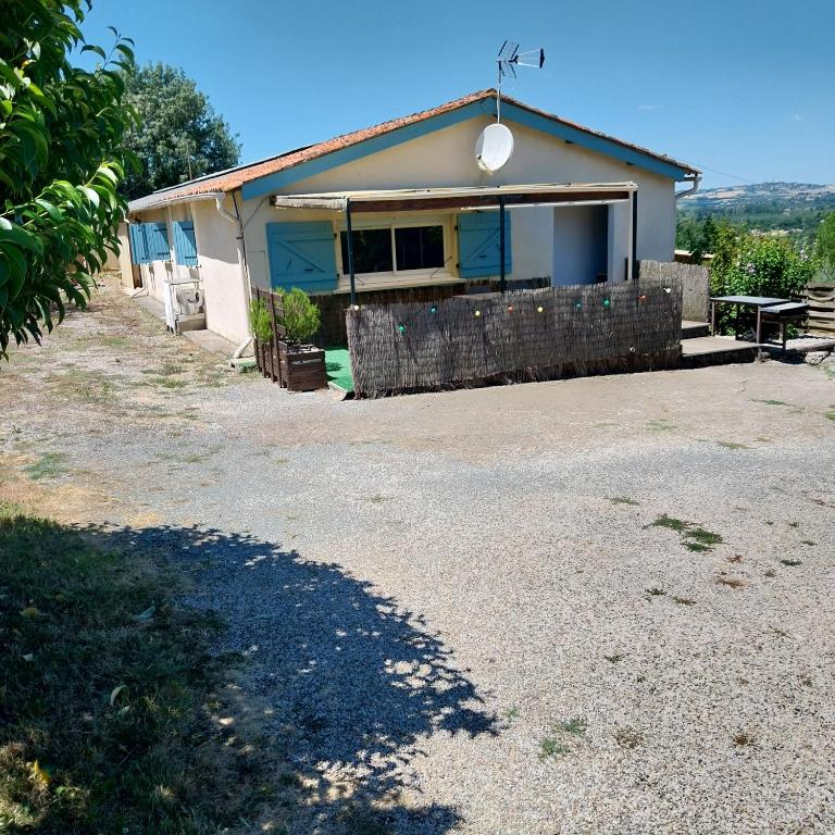 a house with a gravel driveway in front of it at Gites panoramique in Sainte-Livrade-sur-Lot