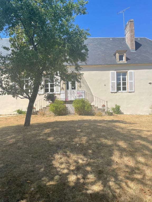 a large house with a tree in front of it at domaine de talon in Talon