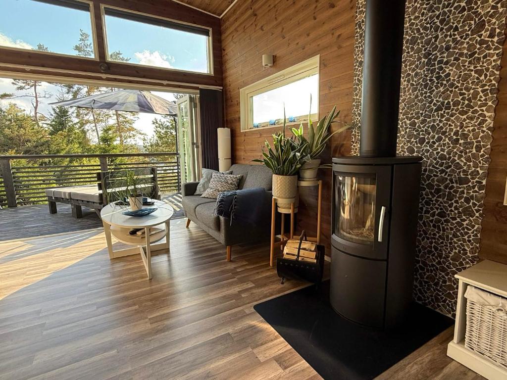 a living room with a fireplace and a couch at Skogsviken Guesthouse in Munkedal