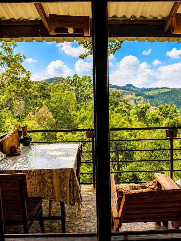a view of a table and chairs from a window at NETHSARA cottage in Ella