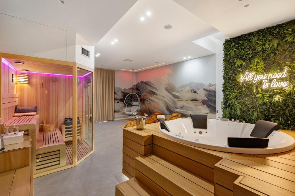 a wellness room with a tub in the middle at La Rocca D'amuri - Alma e Aura in Partinico