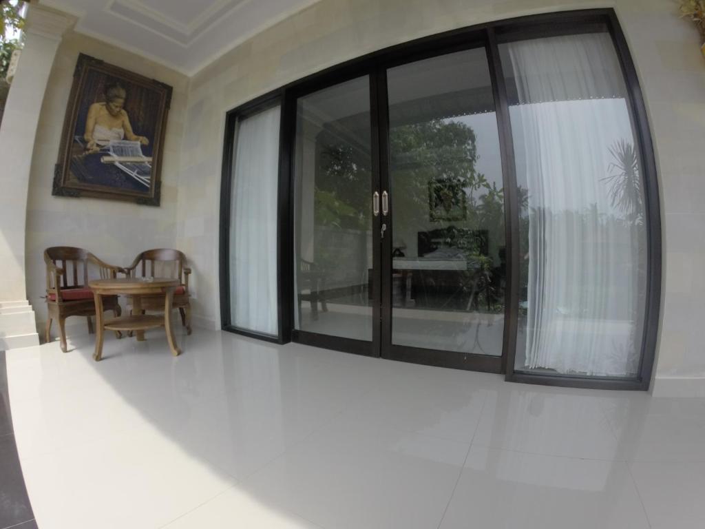 Posezení v ubytování Ubud Wins Bungalow