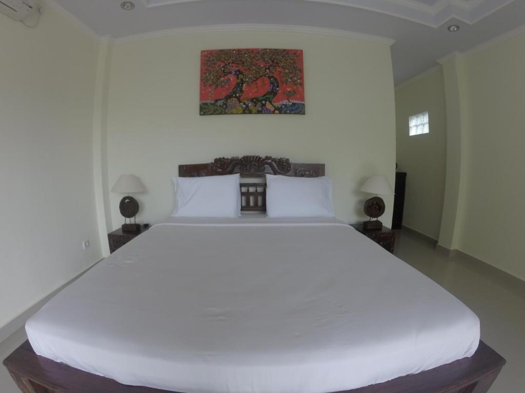 Postel nebo postele na pokoji v ubytování Ubud Wins Bungalow