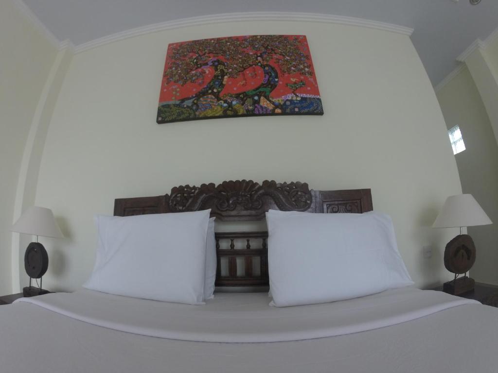 Postel nebo postele na pokoji v ubytování Ubud Wins Bungalow