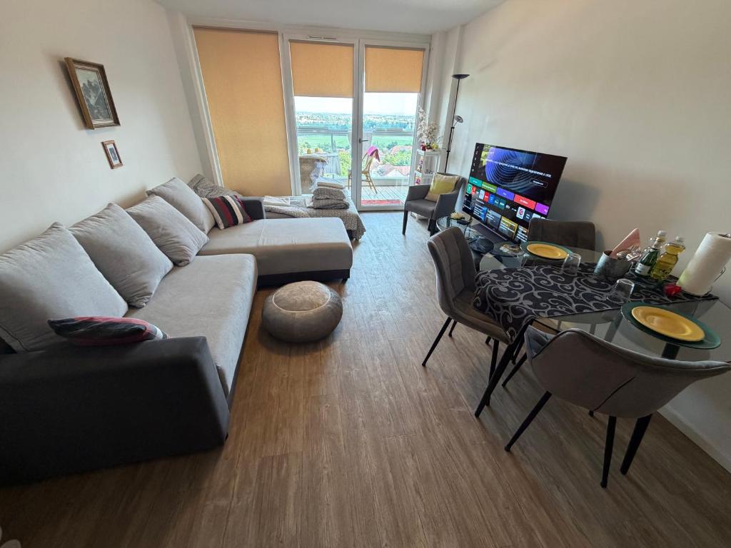 a living room with a couch and a table at Helle Wohnung in Fürth in Fürth