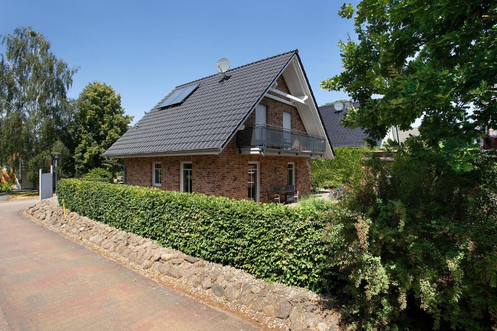 a brown brick house with a black roof at Haus 50 in Röbel