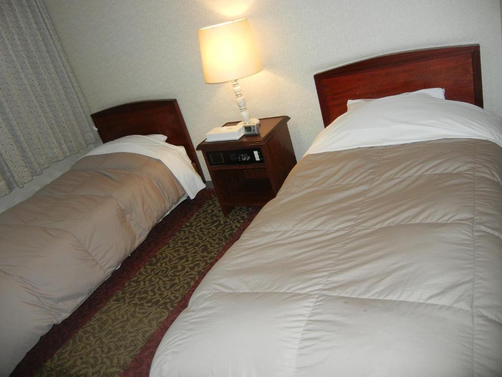 Postel nebo postele na pokoji v ubytování Hotel CROWN HILLS MIYOSHI