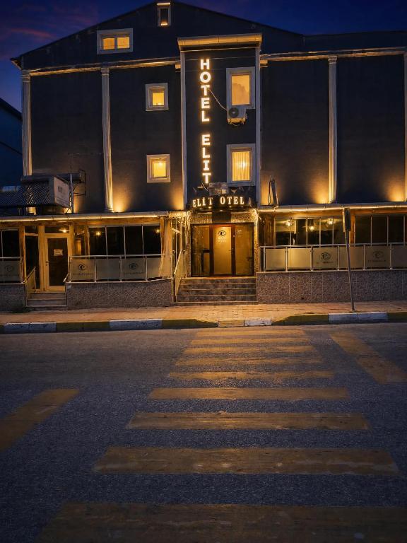 an empty street in front of a building at night at Elite Hotel City Center Saray Bed and Breakfast in Saray