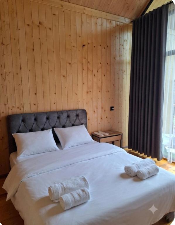 a bedroom with a large bed with two towels on it at AnArt resort in Vanadzor