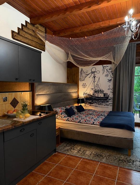 a kitchen with a bed in a room at Kompleks Detlafówka in Dębki