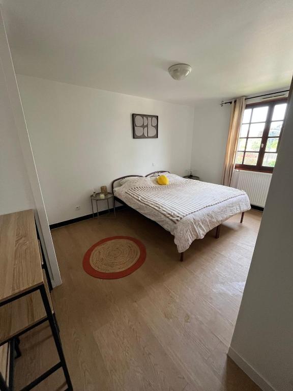 a bedroom with a bed in the corner of a room at Le Pavillon in Vendôme