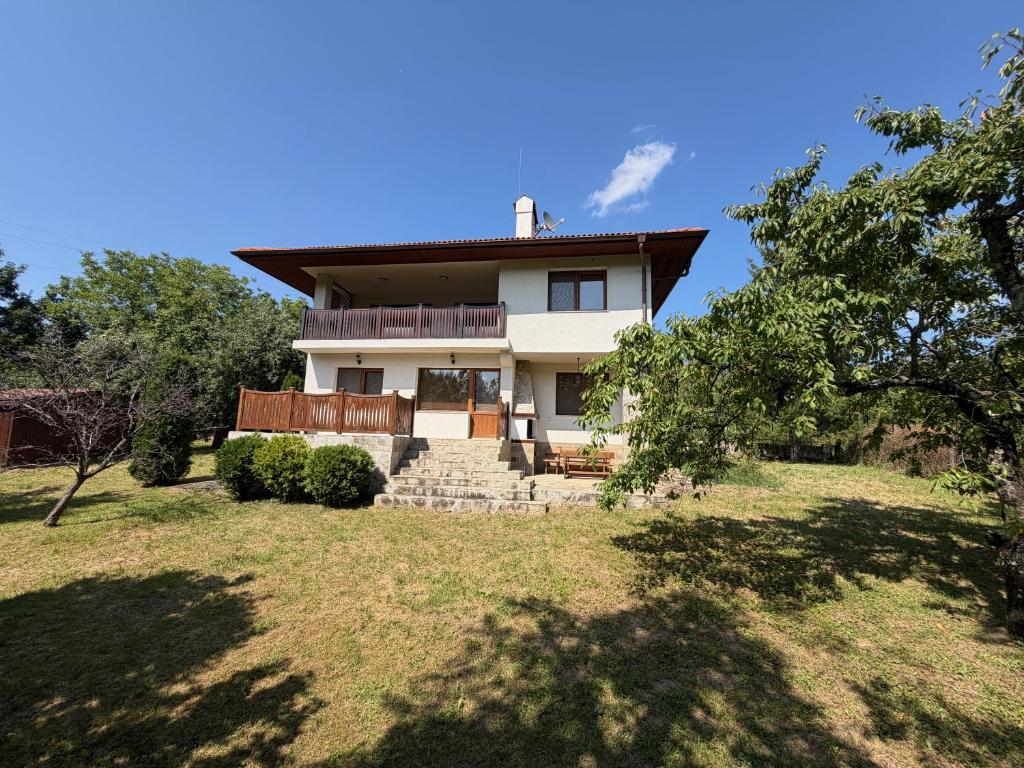 a house on a hill with trees and grass at The Old Walnut House in Terziysko